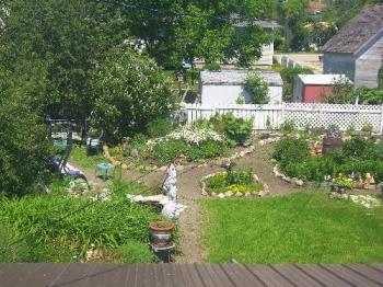 Wide view of our backyard garden - This photo was taken from the upper deck and shows part of our garden. We landscaped the whole yard and gather rocks from the side of the road. It is our little piece of heaven all summer long.