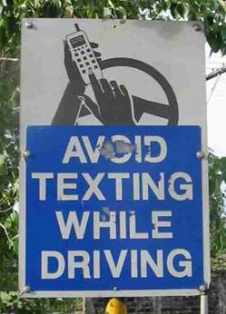 Dont text while you drive - A board instructing all drivers not to text message while driving.