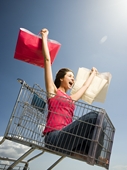 shopping - woman in shopping cart with 2 shopping bags