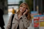 chat it up - Picture of a blonde girl talking on the cell phone wearing khaki petticoat, backdrop of the city