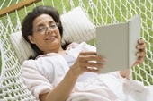 relaxing - photo of woman in hammock reading
