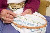 cross stitching - photo of woman doing cross stitch