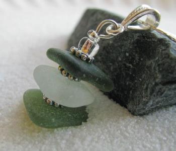 Olive & White Stacked sea Glass Necklace - Triangular shaped authentic sea glass in deep olive, frosty white/clear and light olive green are stacked with sterling silver spacers and clear glass accent beads to complete the gorgeous pendant on this bracelet.
The pendant is approx 1 1/4 in length from the top of the bail to the bottom of the pendant and hangs from an 18" sterling silver chain.

I only use 100% authentic sea glass in my creations. With the exception of drilling a small hole (needed to create some pieces) and a warm water/mild soap bath, I have not altered or enhanced these gems from the sea in anyway.

Available in my etsy.com site.