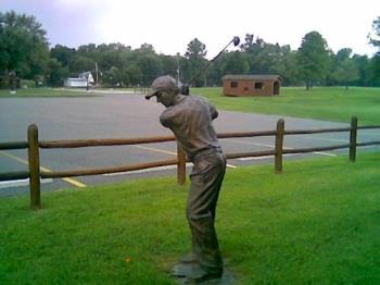 statue of a golfer - This is a statue that stands on the golf range in front of the restaurant there. He looks pretty cool.