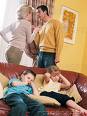 kids like keeping the peace - A couple in each others faces arguing while their two kids are in front of them on the couch slouching and hands over their ears