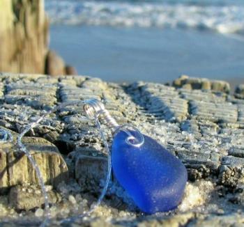 Cobalt Blue Sea Glass Necklace - This pendant/necklace wasn&#039;t getting very many views when it was in my Etsy shop. So my hubby tok it to the beach at the end of November and captured this image (it was about 30 degrees and very windy) 
It sold less than 2 weeks later, most likely because of the new images.