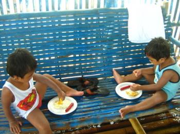 Additional members of the family - My twin grandchildren eating their share of hotdogs and eggs while we were having our breakfast in a raft in the middle of the sea. This was taken in a beach located at Batangas City last summer. Oh my twins, they are a handsome pair!