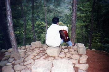 Playing the guitar to beat the chilly morning! - This photo was taken at Banawe, Mountain Province during one of our visits. My son was playing the guitar amidst the cool surroundings and the fresh fragrance of the pine. This is his wonderful way of starting his day.