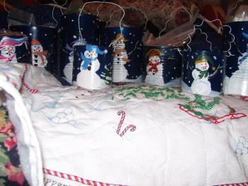 My snowman cans - These were mostly recycled items. I had the paint on hand except for the blue spray paint for the base coat. I put homemade mixes in the large ones, and a votive candle in the small. They were well received.