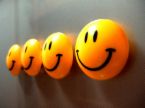 Happiness - A line of happy smiley faces.