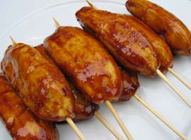 Banana cue. - A local snack made of banana cooked in caramelized sugar. It is often served in stick.
