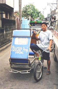 Pedicab - photo from - http://rickshawsetcetera.blogspot.com/2007/04/pedicab-pinoy-innovation.html

A small three-wheeled vehicle having a seat, pedals, and handlebars in front for the operator and a usually hooded cab in back for passengers.

 - answers.com