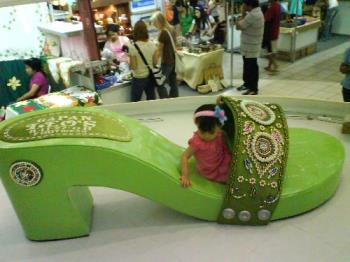 Callia tying the large green sandal... - Large green sandal... will Callia fit in... Callia tying the large green sandal... - Large green sandal... will Callia fit in...