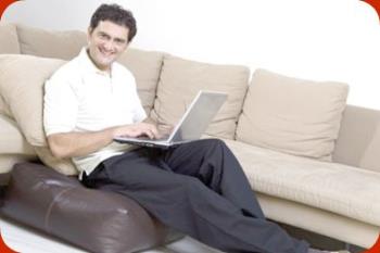 Comfortable in front of the computer - A snapshot of a man sitting comfortably with his laptop.