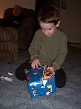 Opening of Christmas Present - A snapshot of a little boy opening his Christmas present / gift.