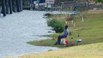 man relaxing while fishing - Man relaxingw hile fishing...does fishing help relax you?