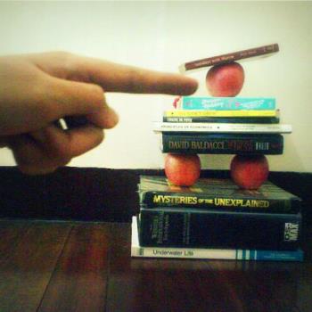 balance in life - A pile of books with 3 apples to balance it and a big hand pointing at the apple which somewhat resembles the Creation of Adam in the Sistine Ceiling by Michaelangelo heheh