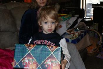 the youngest baby we have - Nicholai holding a gift.