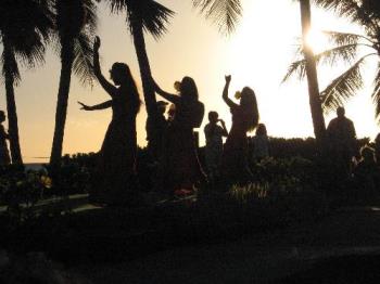 Silhouette at Sunset - This was taken with a Canon Powershot A530. I was seated so my movement was limited and I tried to line up the sun behind a tree and I waited until the dancers came into view.