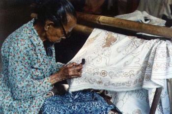 Batik Maker - Baik made by hand drawing using hot candle for the ink.