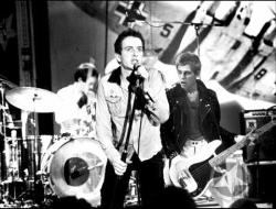 The Clash live on stage - Joe Strummer, Paul simonon, not sure if that&#039;s Topper Headon or Terry Chimes (Tory Crimes) on drums, Mick Jones must be just out of shot 