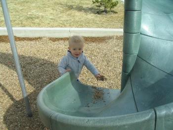 Playing at the Park - putting woodchips on the slide is one of my favorite activities.