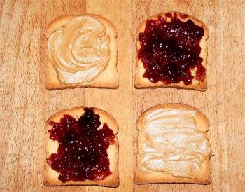 peanut butter and jam sandwich in the making - Here is a peanut butter and jam sandwich in the making. Just add a glass of milk for a snack.