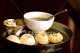 Pani-Puri (golgappa) - Panipuri (Hindi ???????? panipuri, Marathi: ????????, term used in Western India ), 
also known as Gol Gappa (North India), Phuchka (Bengali: ?????) (Bengal), bataashaa or Gup chup is a popular street snack in the Indian subcontinent, especially in India, Pakistan and Bangladesh. It comprises a round, hollow "puri", fried crisp and filled with a watery mixture of tamarind, chili, chaat masala , potato, onion and chickpeas. Its size is small so that it can be placed directly in the mouth.

The term golgappa refers to the fact that crisp sphere ("gol") is placed in the mouth and eaten ("gappa") at one time, without biting. Pani comes from the Hindi word for water and puri (or poori), an Indian bread made by frying dough in oil. It is known as phoochka in Eastern Indian states like Bihar, Jharkhand and West Bengal and in Bangladesh, because of the bursting sound in the mouth when it is eaten. It is known as GupChup in Orissa and 
South Jharkhand.