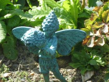 Green Faerie With Cone - My favourite garden ornament is this green faerie holding a cone.