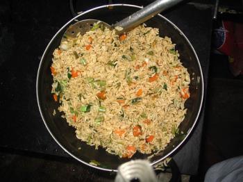 cooked rice with vegetables. - cooked rice with some vegetables which is staple food in india.