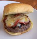 pizza burger - from http://kidscooking.about.com/b/2008/06/19/pizza-burgers.htm

One easy way to broaden the palates of your picky eaters is to take two foods you know they like, and put them together. These pizza burgers are a great example.
Serve these pizza burgers with roasted green beans and Italian pasta salad.

Ingredients:

1-1/2 lbs. 85% lean ground beef
1/2 tsp. kosher salt
1/2 tsp. freshly-ground black pepper
12-18 slices regular or turkey pepperoni
6 slices provolone cheese
ketchup
potato bread hamburger buns
Preparation:

Prepare grill or heat a cast iron grill pan on the stove over medium heat.

Combine ground beef, salt and pepper. Form into 6 patties, being careful not to overwork the meat. (Click here for more tips on grilling perfect burgers)

Grill burgers 2-4 minutes. Flip.

Top each burger with 2-3 slices pepperoni and a slice of cheese. Grill to desired doneness, another 2-4 minutes.

Place burgers on buns. Squirt with ketchup.
Serve immediately.