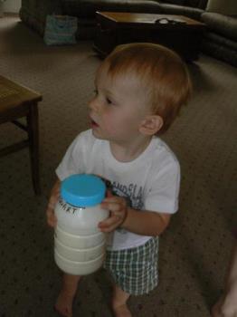 my son helping make butter - This is a picture of my son today shaking up the bottle to make butter. It was so easy even he could do it and he is only 1 and 1/2.