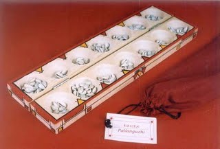 pallanguzhi, South Indian game - The image of pallanguzhi game played with shells.