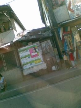 children - children in the side of a busy street. they are usually seen staying there most of the day.