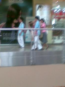 school uniform - college students seen strolling in a mall in their school uniform