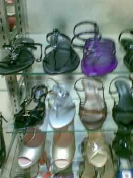 sandals - sandals and other footwear on display in a mall