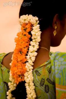 a woman with flowers on her hair - The image of a woman with flowers on her hair a woman with flowers on her hair - The image of a woman with flowers on her hair