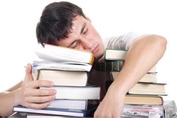 Sleeping man - Man sleeps on a pile of books