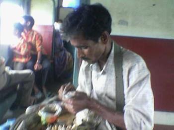 badamwala - A man selling out pea nuts in a local train