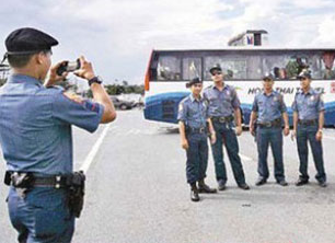 cops taking picture on the crime scene - as if it&#039;s a tourist spot