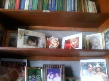 Picture frames of my niece and nephew - The picture frames of my niece and nephew are displayed on the shelf that is located at the other room which is the office of my dad. 