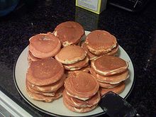 Pancakes - These are Stacks of "silver dollar" pancakes.

A silver dollar pancake refers to a pancake about two to three inches (5 to 7 cm) in diameter, or just a bit bigger than the pre-1979 silver dollar coins in the United States, for which they are named. It is usually made by frying a small spoonful of the same batter as any other pancake. One serving is usually five to ten silver dollar pancakes.