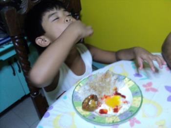 Enjoying his food - Eating by hands