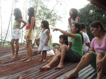 Flood victims on their rooftop - Flooding brought about too much damage to to lives and properties.