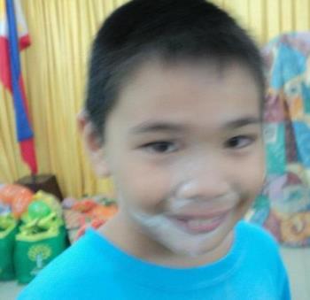 Smiling kid - Smile though your face is covered with flour