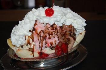 Banana Split is an ice-cream based dessert with a - Banana Split is an ice-cream based dessert with a banana cut in half Banana Split is an ice-cream based dessert with a - Banana Split is an ice-cream based dessert with a banana cut in half