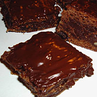 Yummy brownies with chocolate over it.