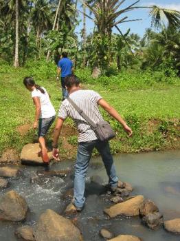 crossing the river - This is the picture of my group mates who are crossing the river while on our way to the place where we conducted a monitoring and evaluation of some projects. 