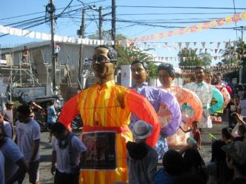 Higantes Festival - Angono Rizal - Every November 22 and 23 - a little town in Rizal province celebrates the town fiesta. It is called Higantes Festival. It is one of the well-known Festivals in the PHilippines. Different paper mache giants in human figures are formed. These giants paper mache parade in the town. Every year, new character is being introduced, this year, they had politicians in paper mache like the first one shown here is President Noynoy Aquino, on which the third is President Marcos. Activities such as Dance of the Higantes (Higantes dance), Games of the Higantes (games were participated by the higantes). Majorettes and marching bands competition (again most majorettes and marching bands came from the town, we have a lot of marching bands but other marching bands and majorettes from different towns can join the competition also) and so on. These activities are hold every 22nd of November the eve of the feast day itself. The day is November 23 when there will be a long procession in honor of San Clemente our patron saint. There are street dancers in fisherman/woman costume, higantes, marching bands and majorettes and town people dressed in different costumes (Like mardigras). People from the side streets who are watching also throw water to the everyone from the participants to guests. (they not spared from this). Because Saint Clement was found in Laguna de Bay, Angono part years ago. The spirits are high and everyone enjoys the event. 