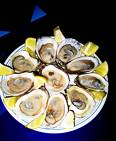 Oysters of the Half Shell - Picture of oysters on the half shell with lemons